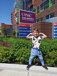 Tiago posing in front of UPMC Children's Hospital of Pittsburgh